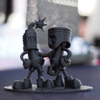 Black Cloud Chibi Piston and Spark Plug black acrylic figurine.