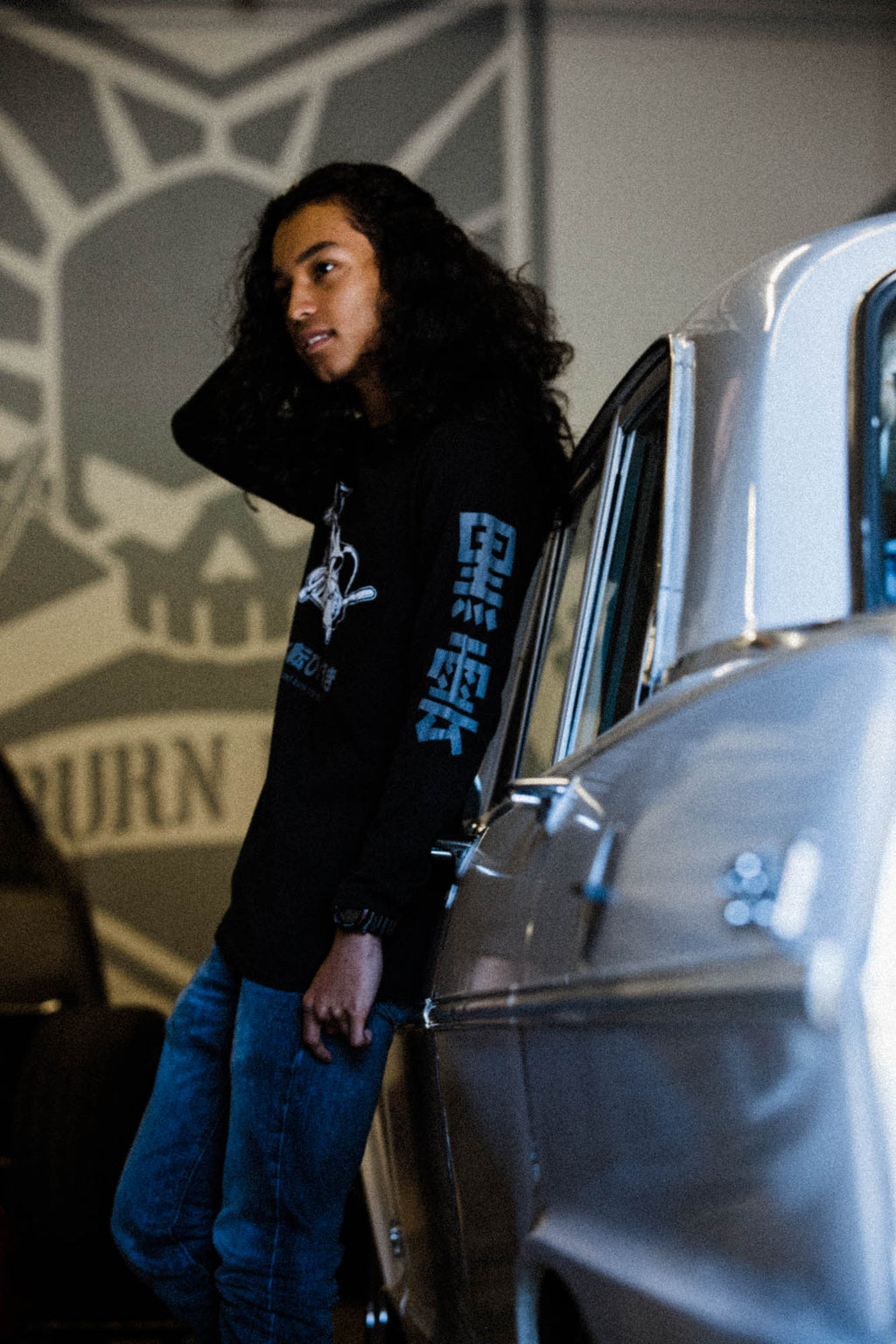 Black unisex cotton long-sleeved T-shirt with frontside scare skateboarding jack design on front in white and gray ink. Black cloud kanji in gray down the sleeves.