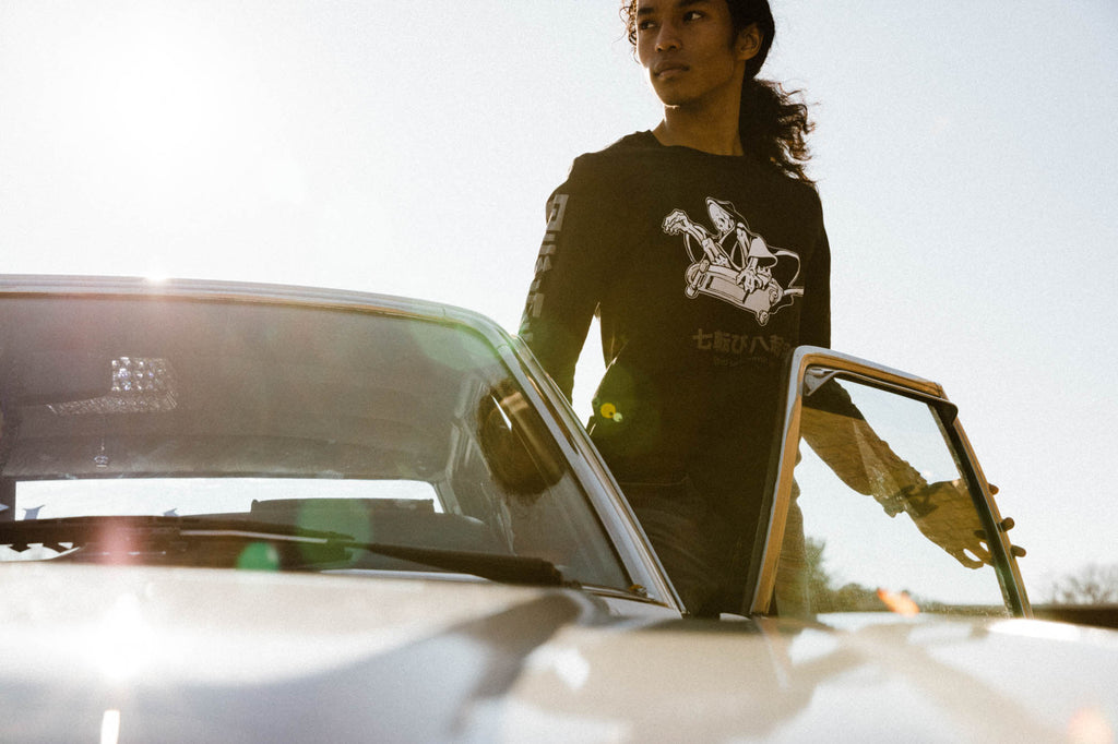 Black unisex cotton long-sleeved T-shirt with frontside scare skateboarding jack design on front in white and gray ink. Black cloud kanji in gray down the sleeves.