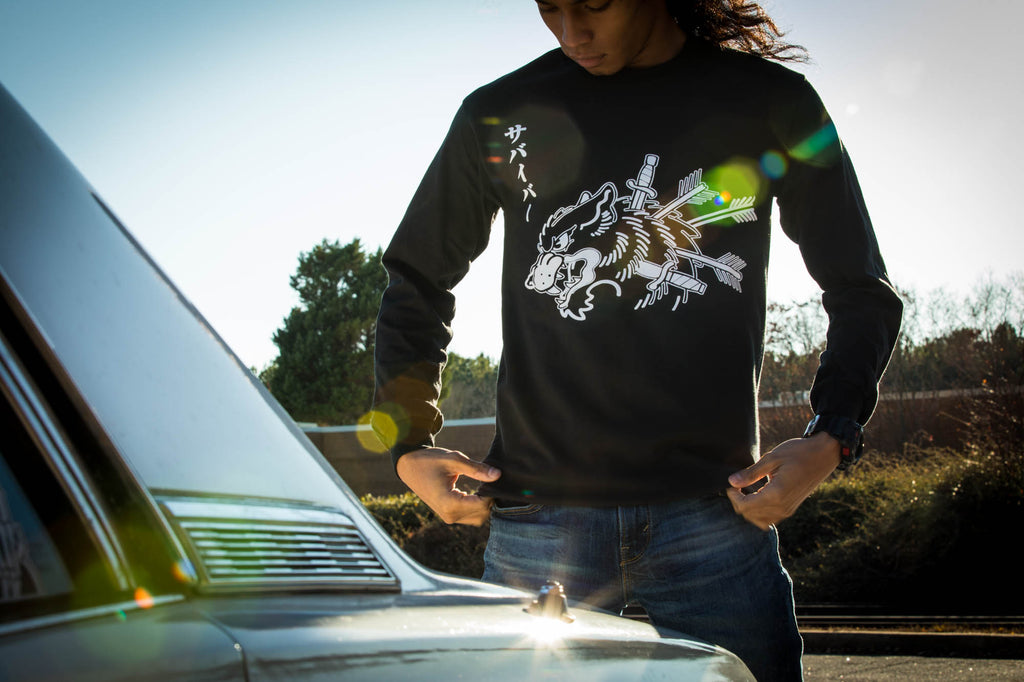 Black unisex cotton short-sleeved T-shirt with survivor design on front in white ink.