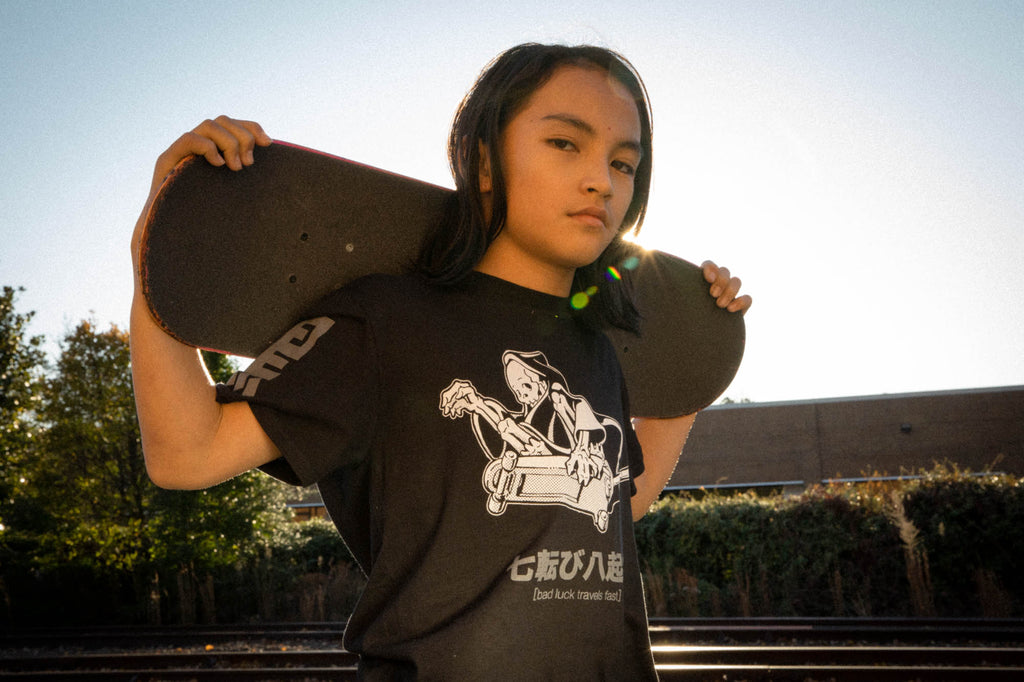 Black unisex cotton short-sleeved T-shirt with frontside scare skateboarding jack design on front in white and gray ink. Black cloud kanji in gray down the sleeves.