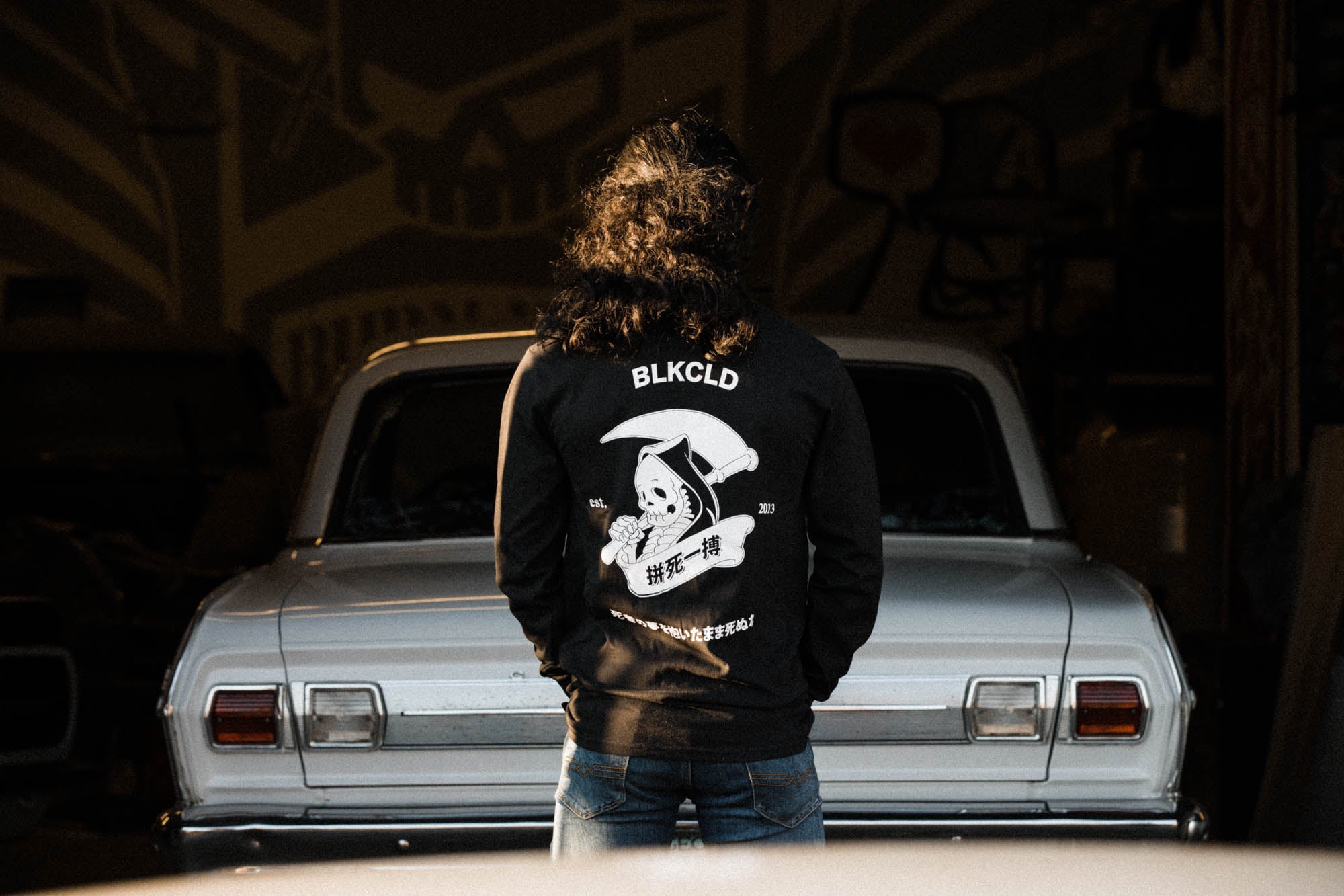 Black unisex cotton long-sleeved T-shirt with Grim Reaper Do or Die design on back in white ink. 