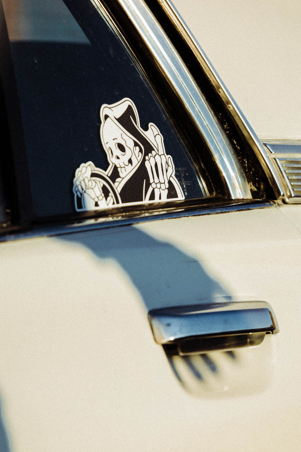 Black and white vinyl “peeker” reaper sticker. 