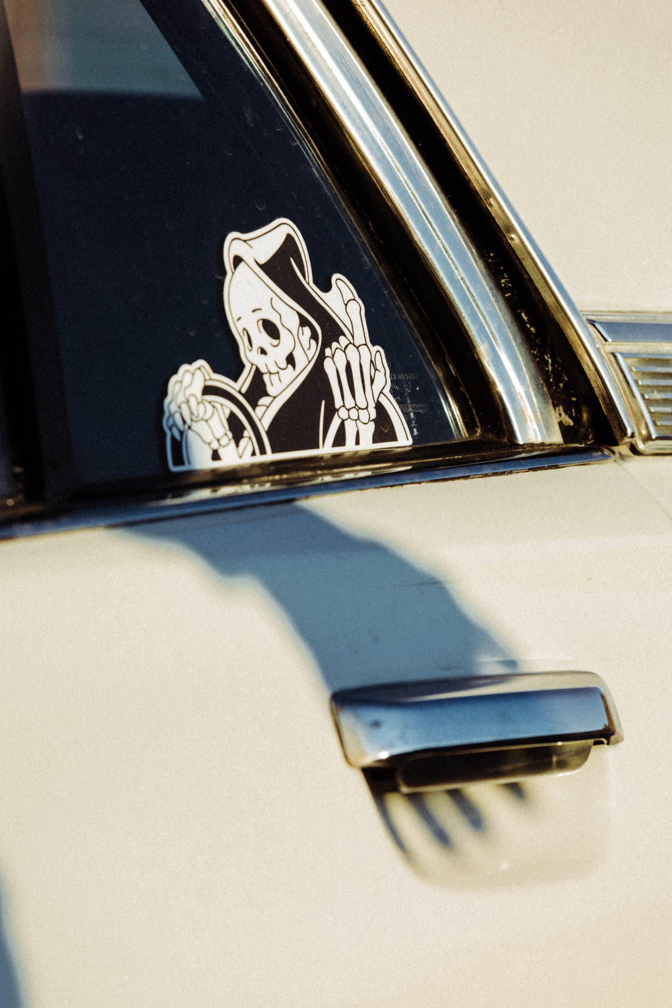 Black and white vinyl “peeker” reaper sticker. 