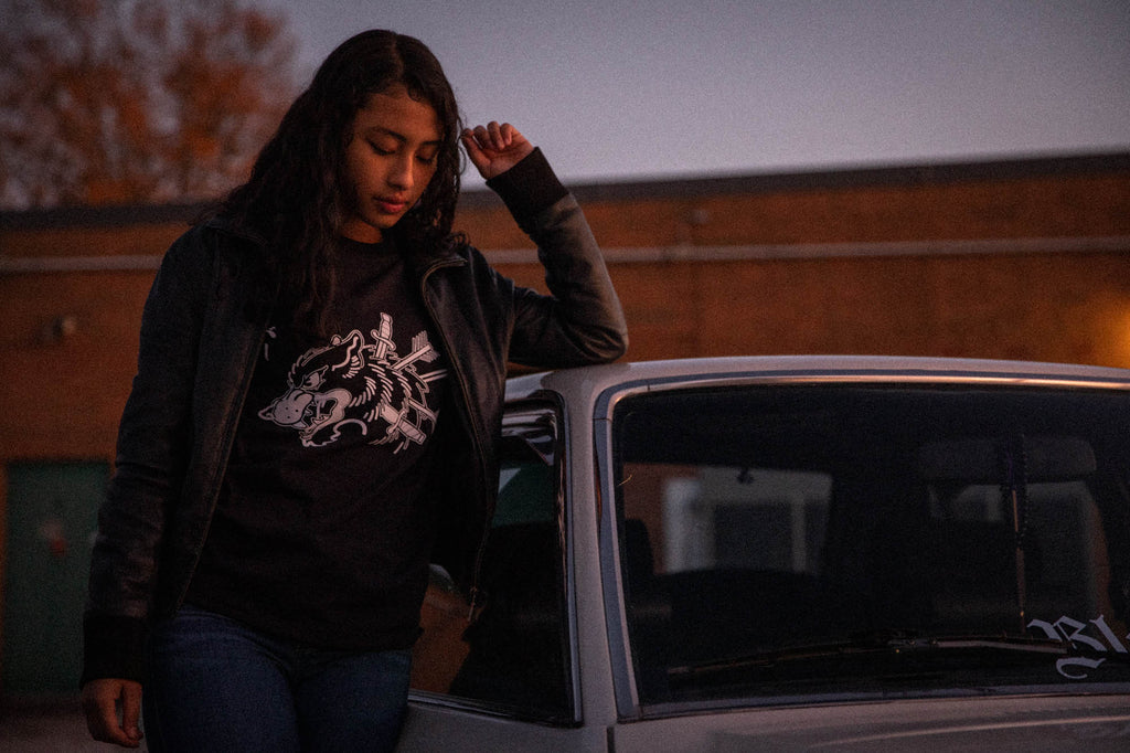 Black unisex cotton short-sleeved T-shirt with survivor design on front in white ink.