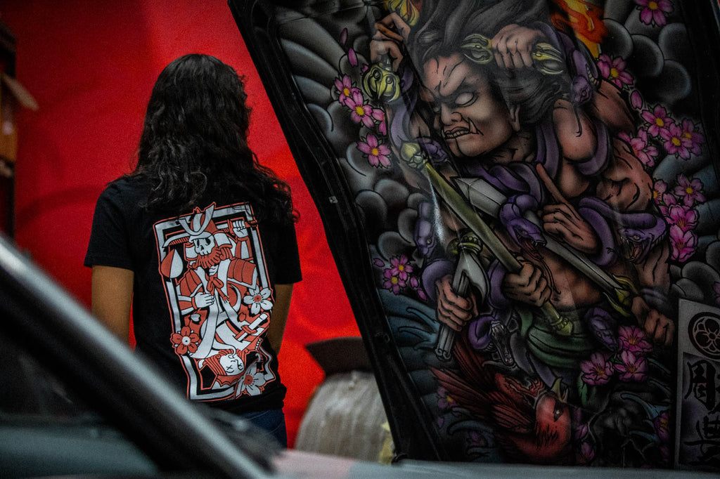 Black unisex cotton T-shirt with pink and white  Kyusha's wager playing card full back print. 