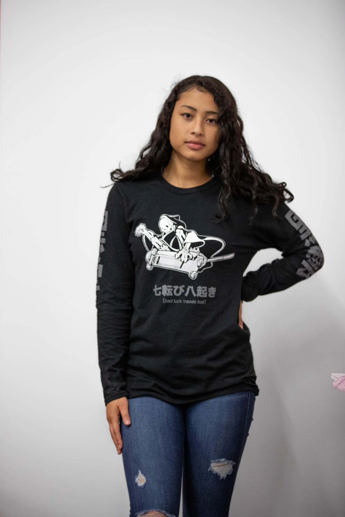 Black unisex cotton long-sleeved T-shirt with frontside scare skateboarding jack design on front in white and gray ink. Black cloud kanji in gray down the sleeves.