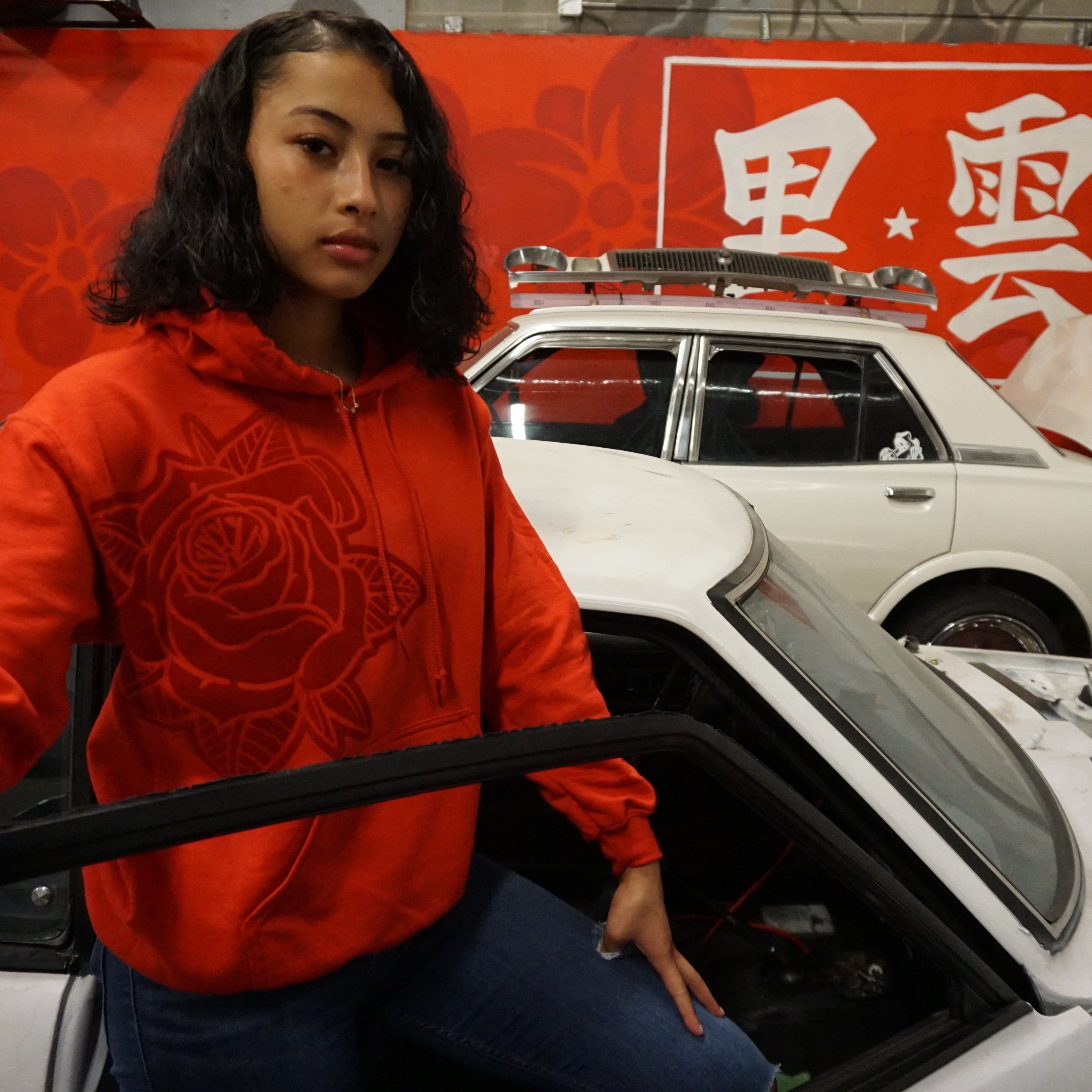 Unisex Pretty PSI red hoodie with turbo rose design on front in red velvet flock and black cloud Japanese kanji characters in red velvet flock on back.