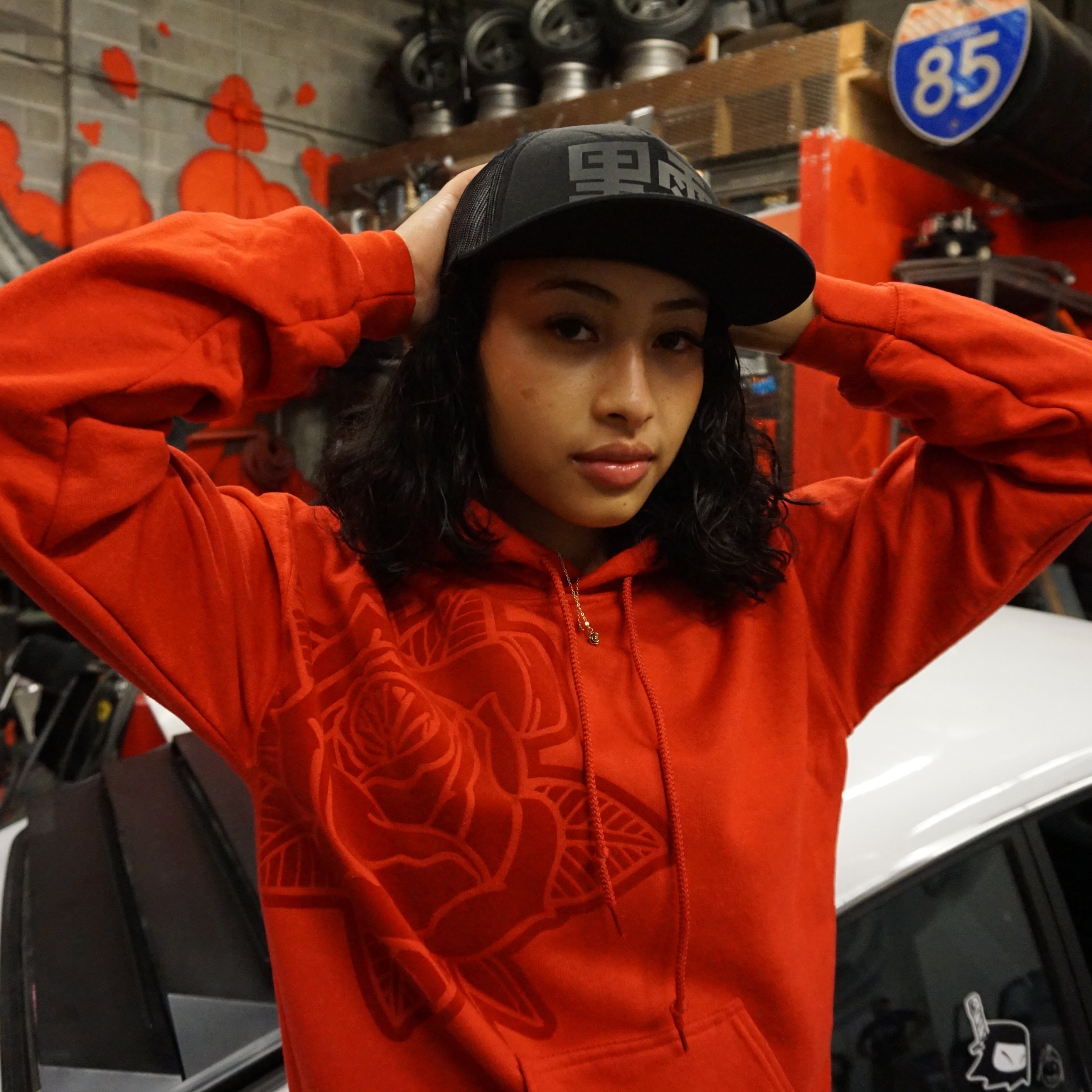 Unisex Pretty PSI red hoodie with turbo rose design on front in red velvet flock and black cloud Japanese kanji characters in red velvet flock on back.