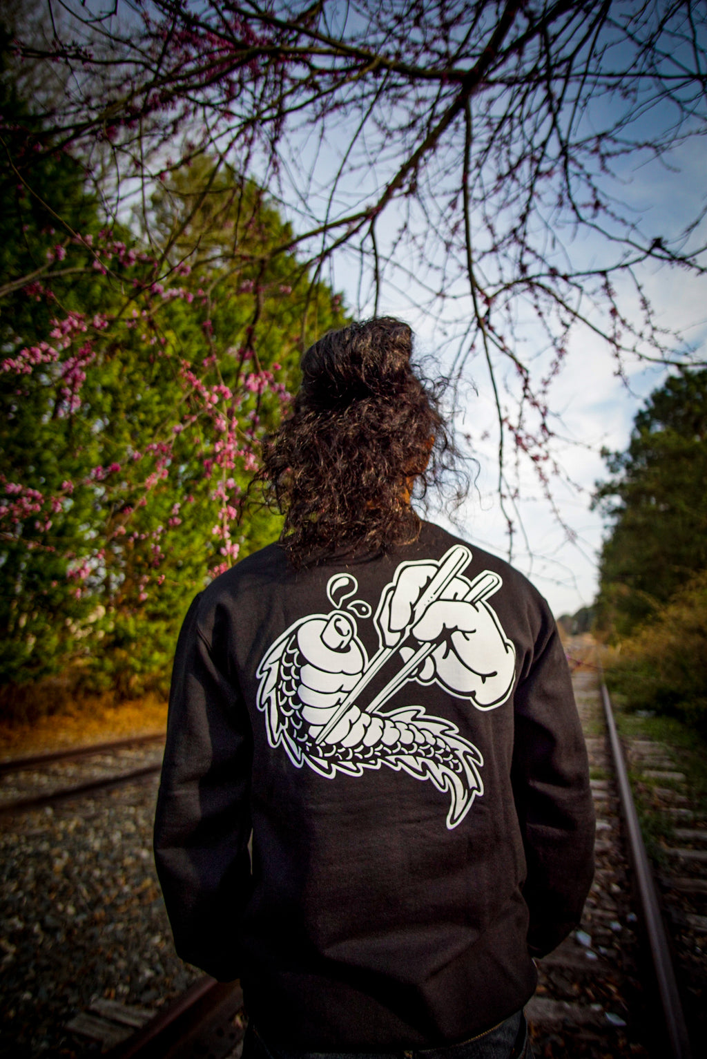 Unisex black crewneck sweatshirt with tōge (roadway) chest emblem on front in white ink and conquering the tail of the dragon design in white on back.
