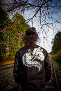Unisex black crewneck sweatshirt with tōge (roadway) chest emblem on front in white ink and conquering the tail of the dragon design in white on back.