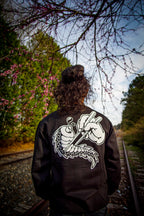Unisex black crewneck sweatshirt with tōge (roadway) chest emblem on front in white ink and conquering the tail of the dragon design in white on back.