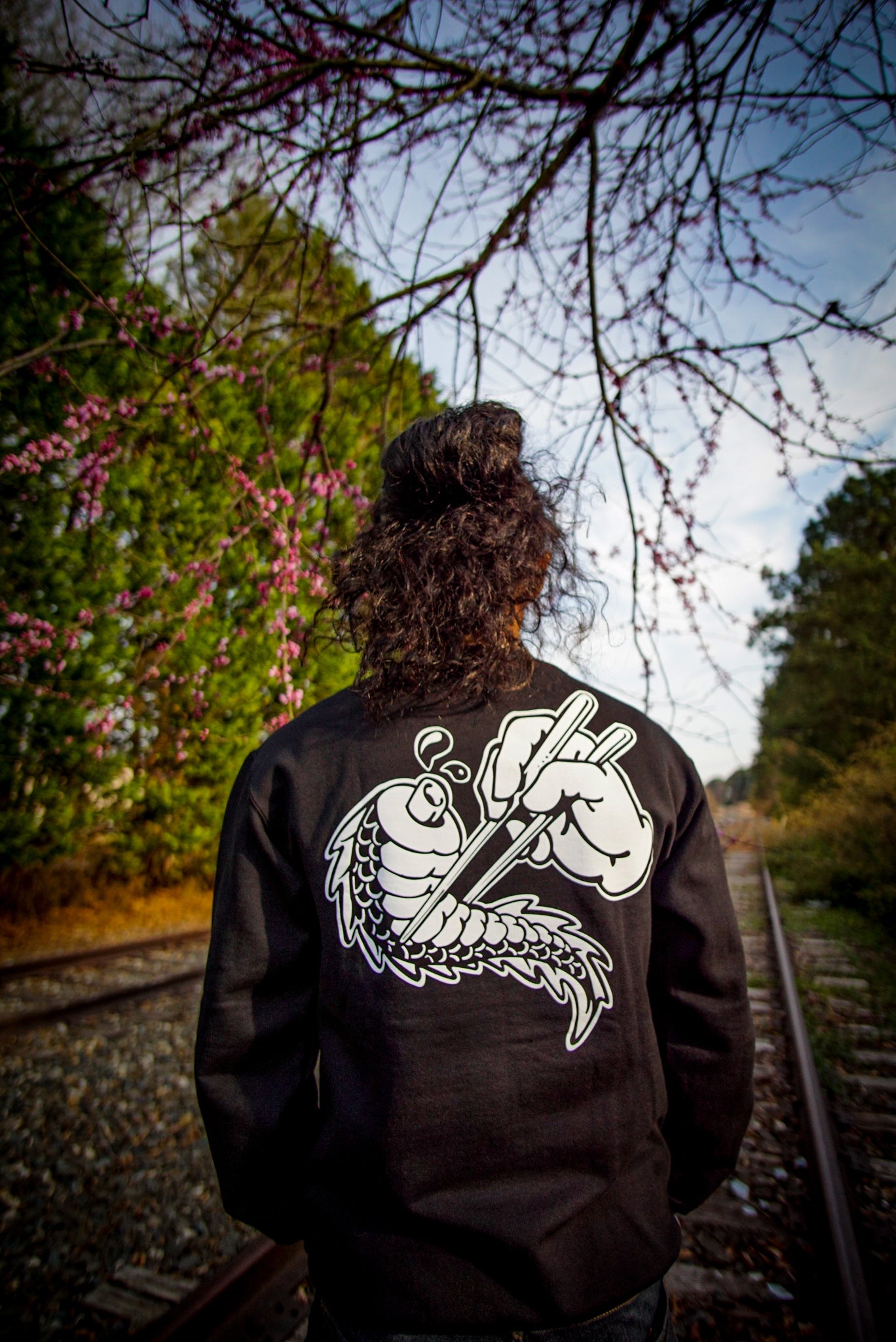 Unisex black crewneck sweatshirt with tōge (roadway) chest emblem on front in white ink and conquering the tail of the dragon design in white on back.