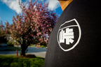 Unisex cotton black crewneck sweatshirt with tōge (roadway) chest emblem on front in white ink and conquering the tail of the dragon design in white on back.