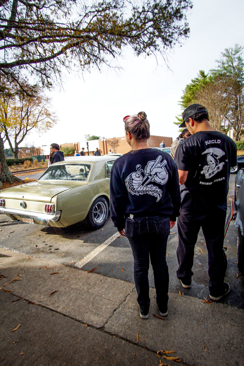 Unisex cotton black crewneck sweatshirt with tōge (roadway) chest emblem on front in white ink and conquering the tail of the dragon design in white on back. And Do or Die Reaper unisex T-shirt.