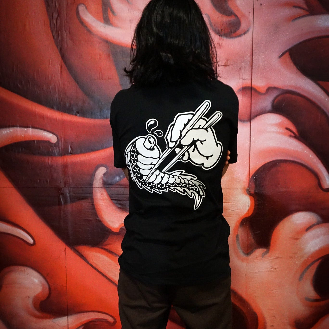 Black cotton unisex short-sleeved T-shirt with conquering the Tail of the Dragon design in white on the back.