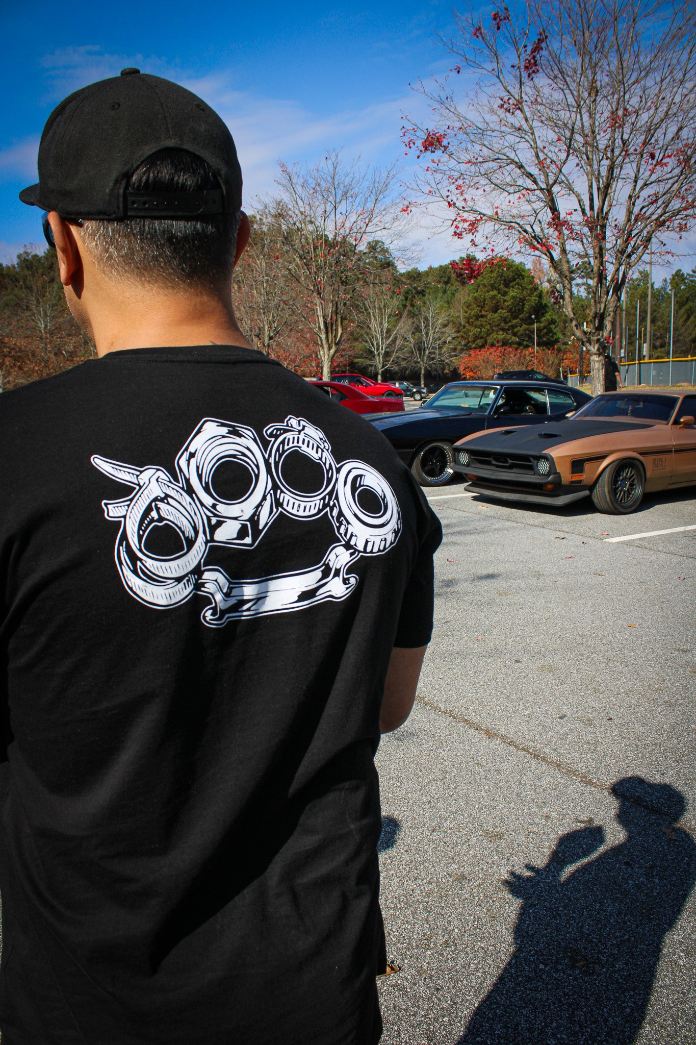 Black cotton short-sleeved T-shirt with Problem Solver brass knuckle design on back in white ink
