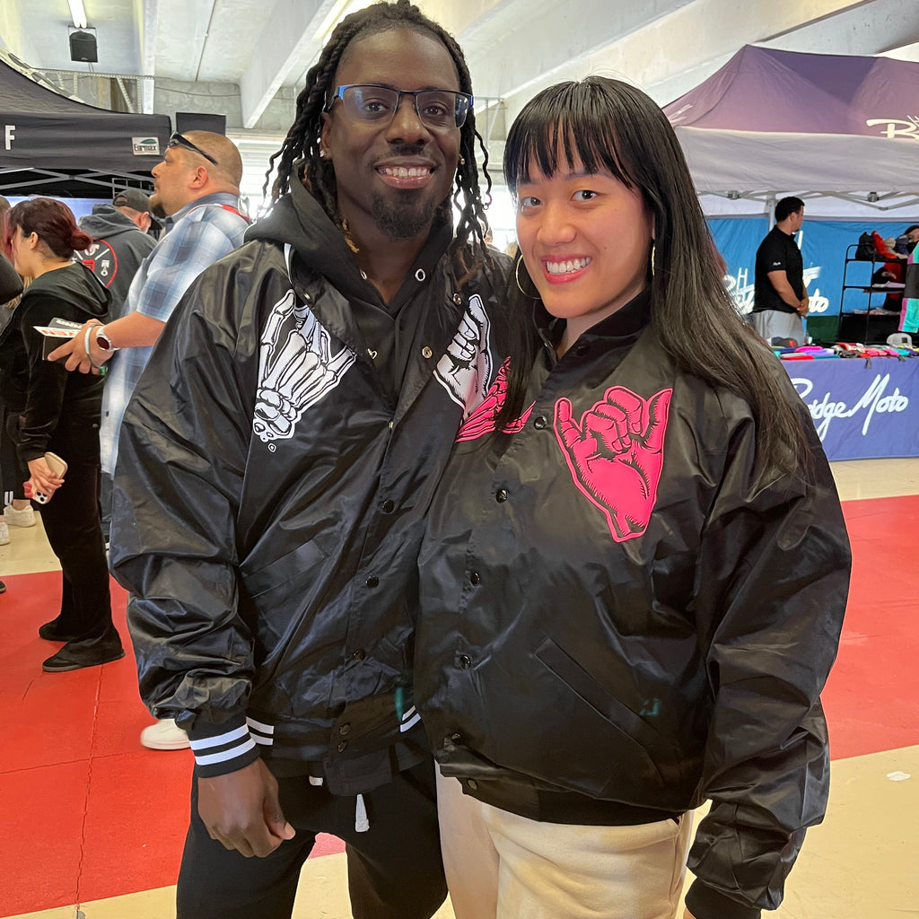 His and hers black unisex nylon lined baseball jacket with promise (Yakusoku) design on front in white or hot pink