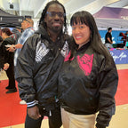 His and hers black unisex nylon lined baseball jacket with promise (Yakusoku) design on front in white or hot pink
