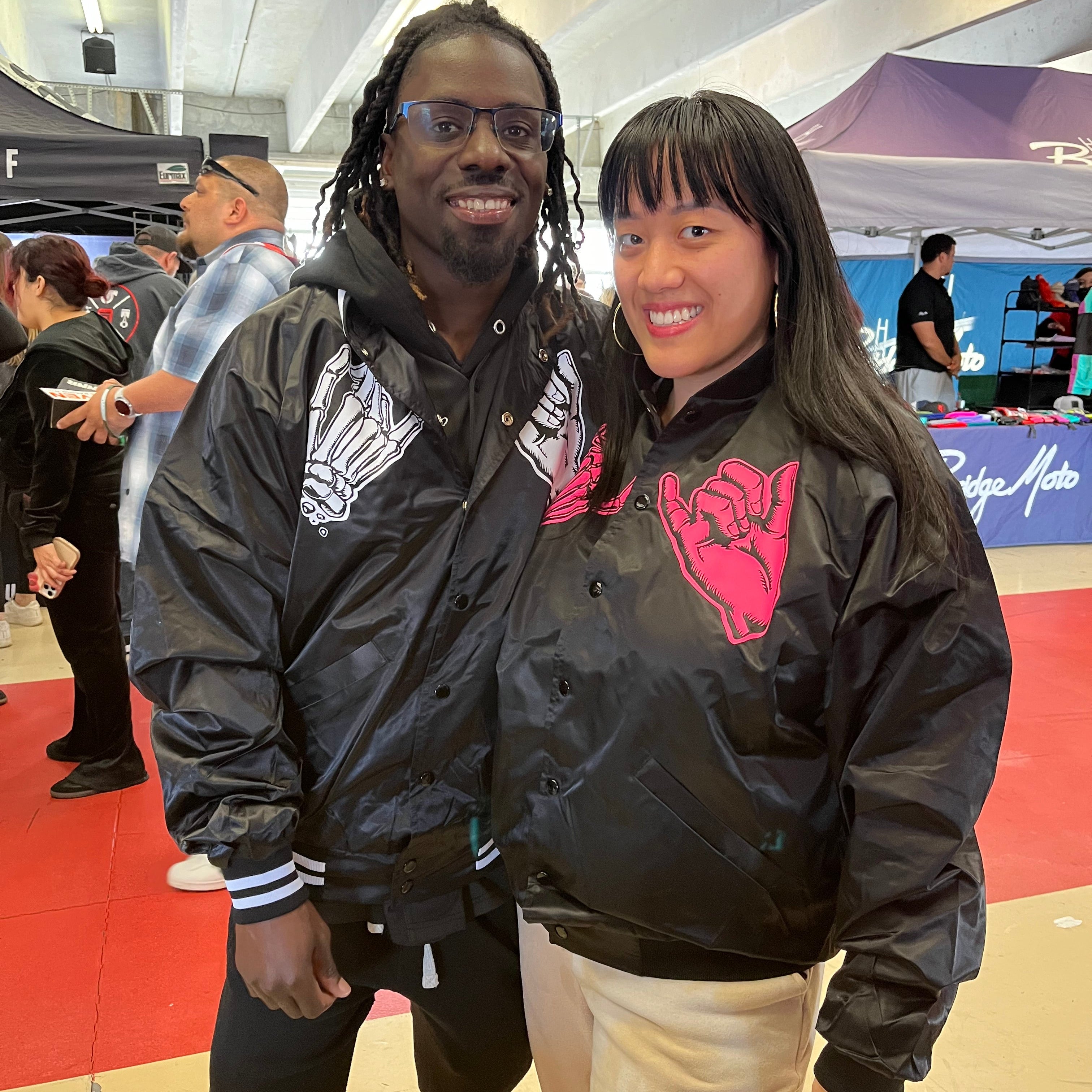 His and hers black unisex nylon lined baseball jacket with promise (Yakusoku) design on front in white or hot pink