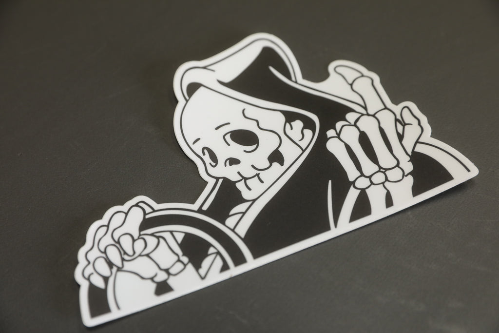 Black and white vinyl “peeker” reaper sticker. 