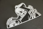 Black and white vinyl “peeker” reaper sticker. 