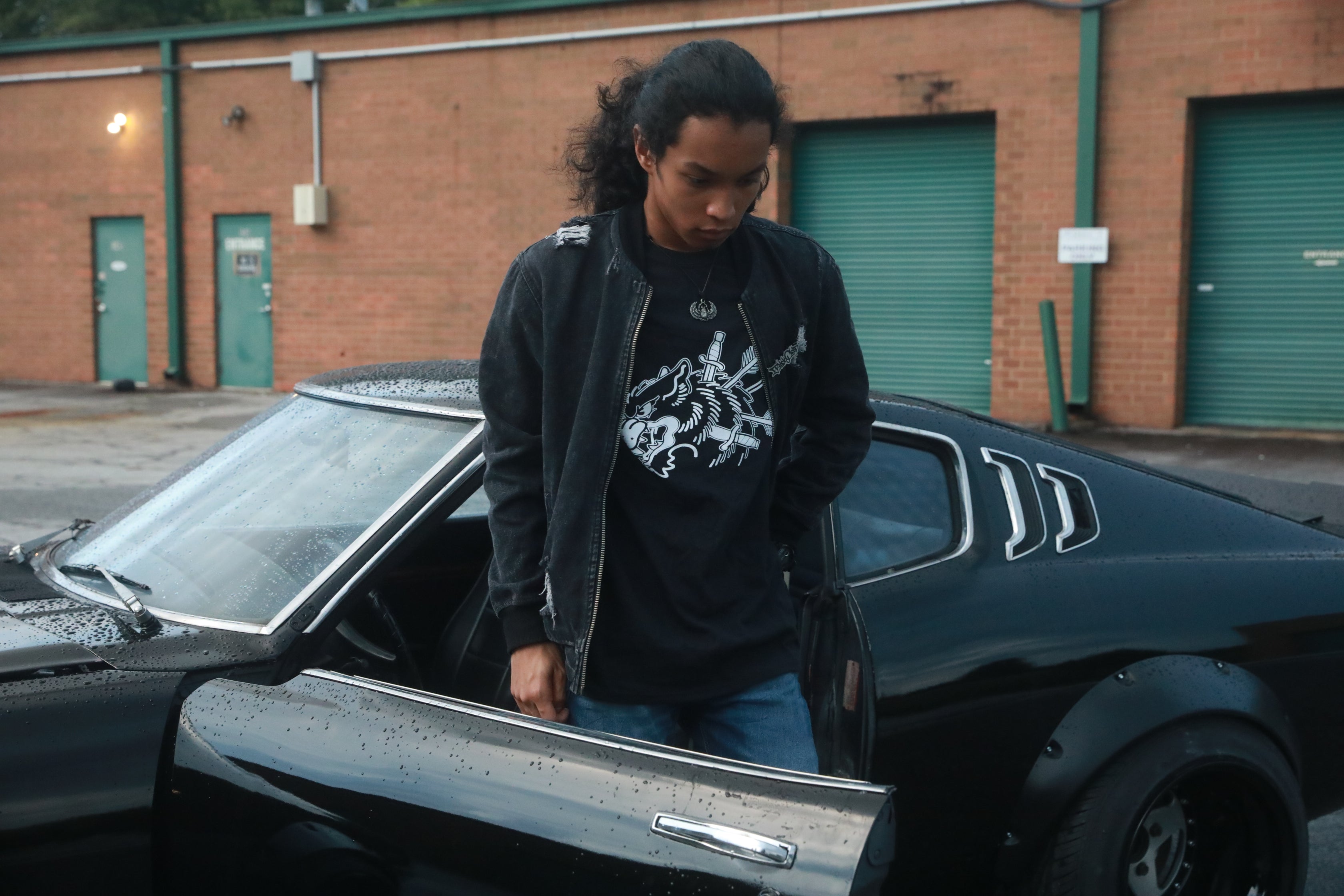 Black unisex cotton short-sleeved T-shirt with survivor design on front in white ink.