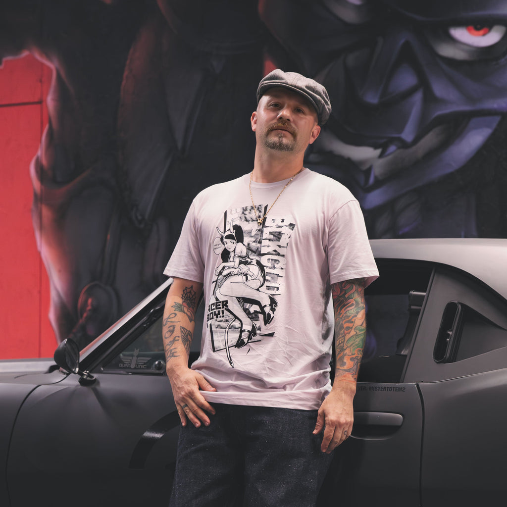 Orchid pink unisex cotton short-sleeved T-shirt with racer boy design on the front in white and black ink.
