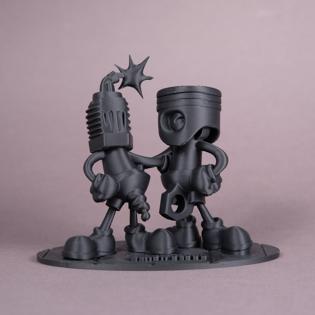 Black Cloud Chibi Piston and Spark Plug black acrylic figurine.