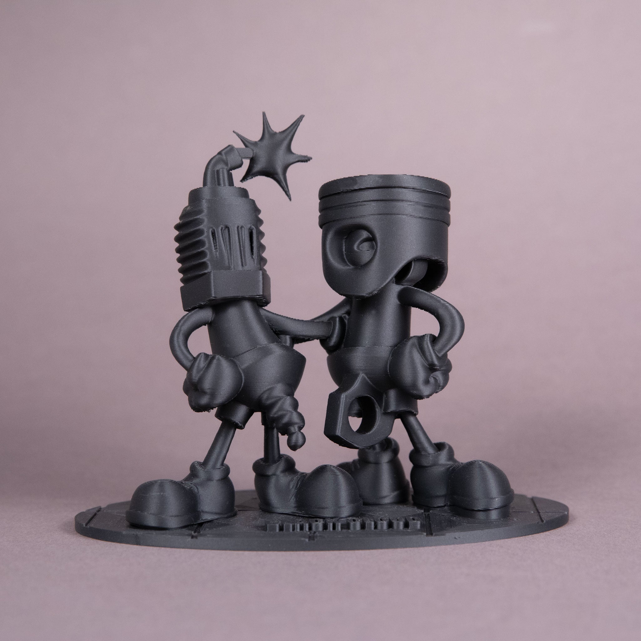 Black Cloud Chibi Piston and Spark Plug black acrylic figurine.