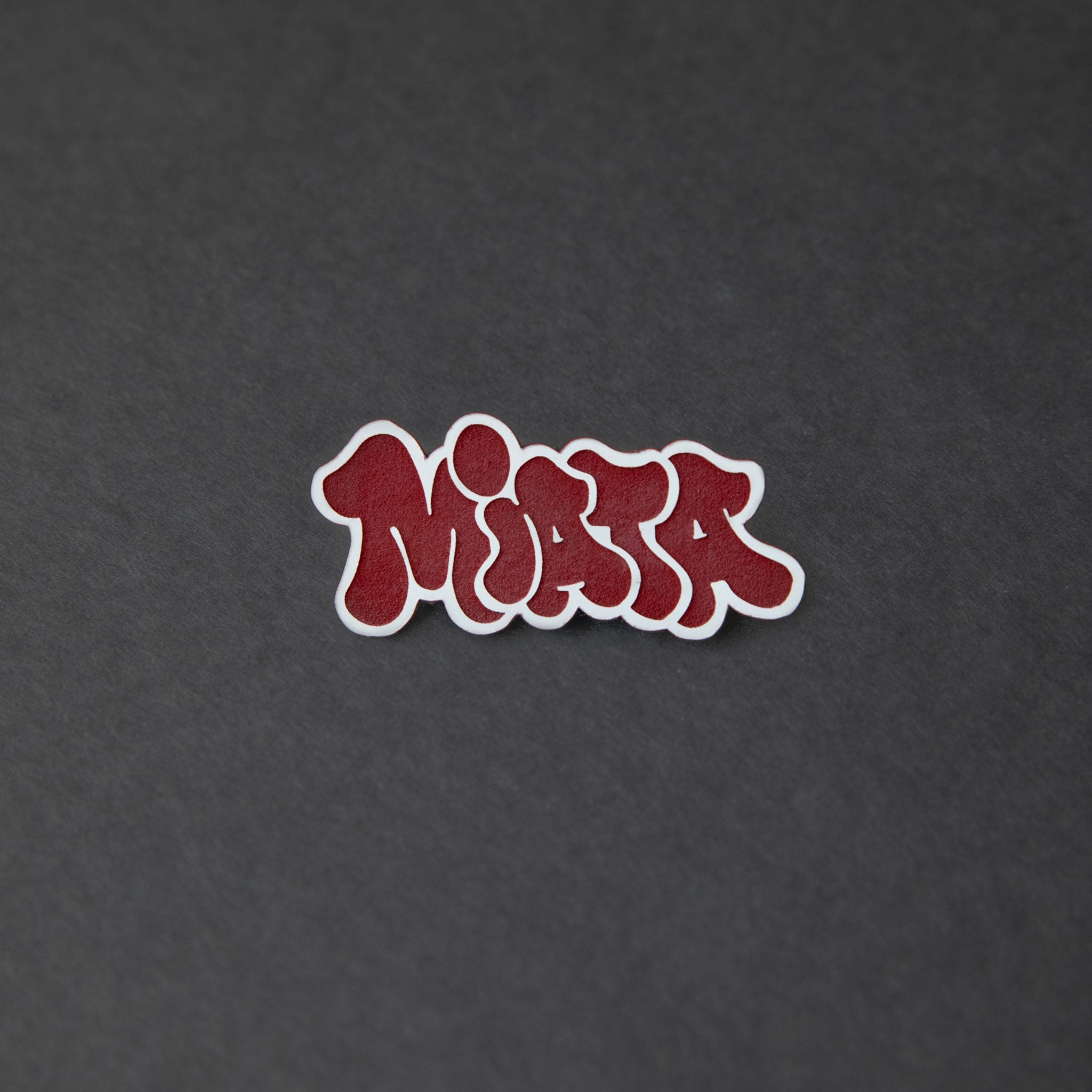 Red and white laser-engraved acrylic miata hair clip.