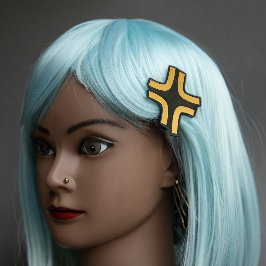 Black and gold laser-engraved acrylic Black Cloud angry anime symbol hair clip.