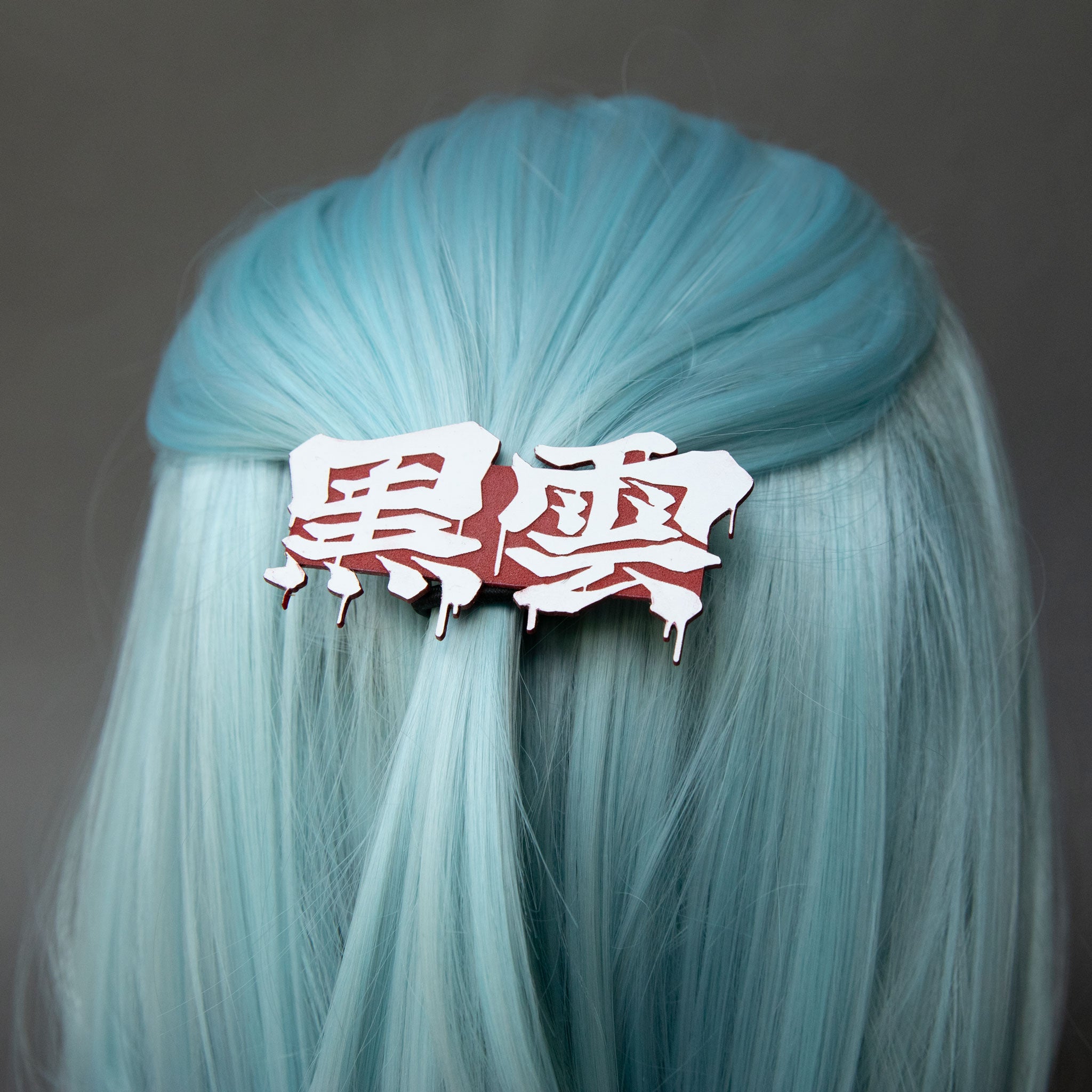 Red and white laser-engraved acrylic Black Cloud Japanese Kanji hair clip.