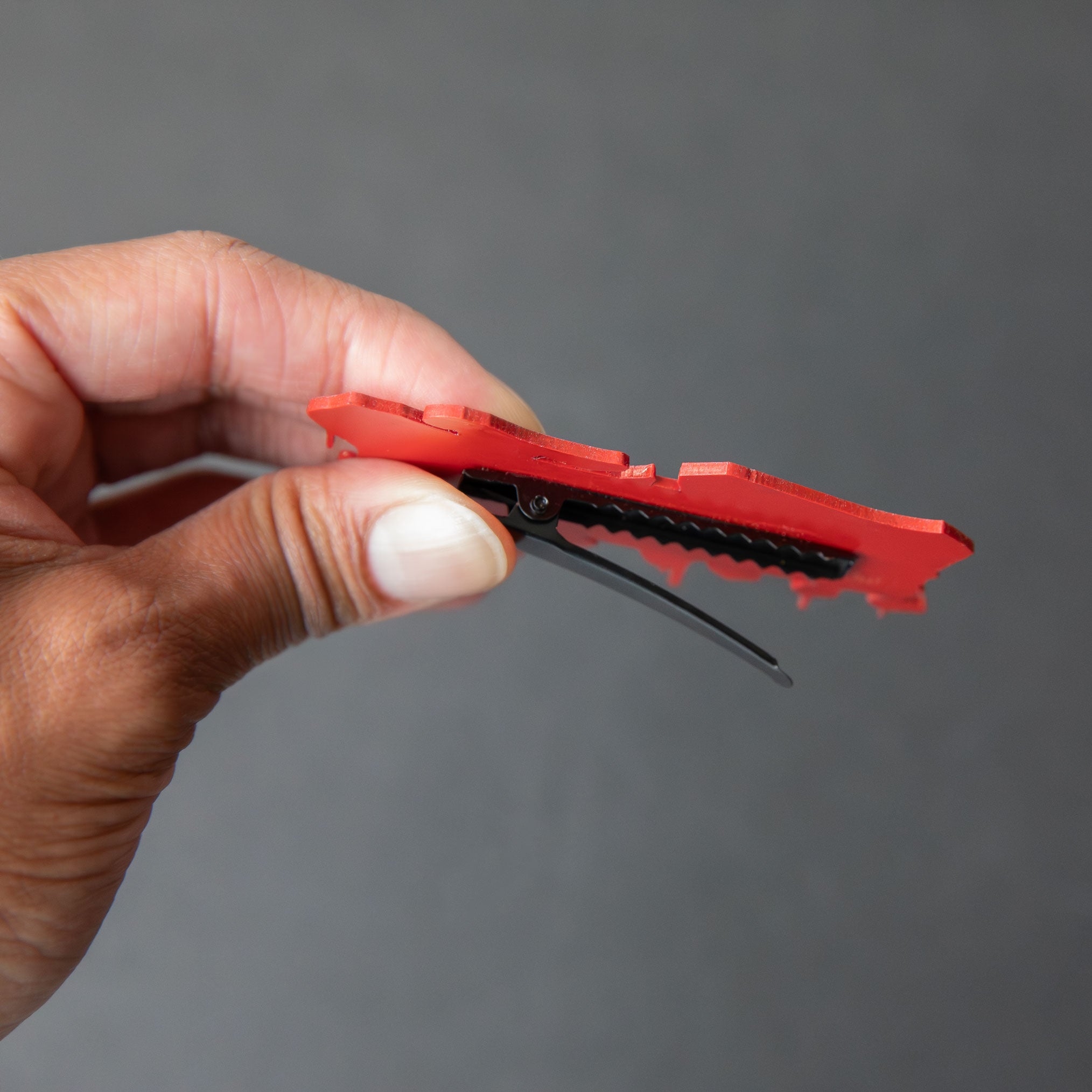 Red and white laser-engraved acrylic Black Cloud Japanese Kanji hair clip.