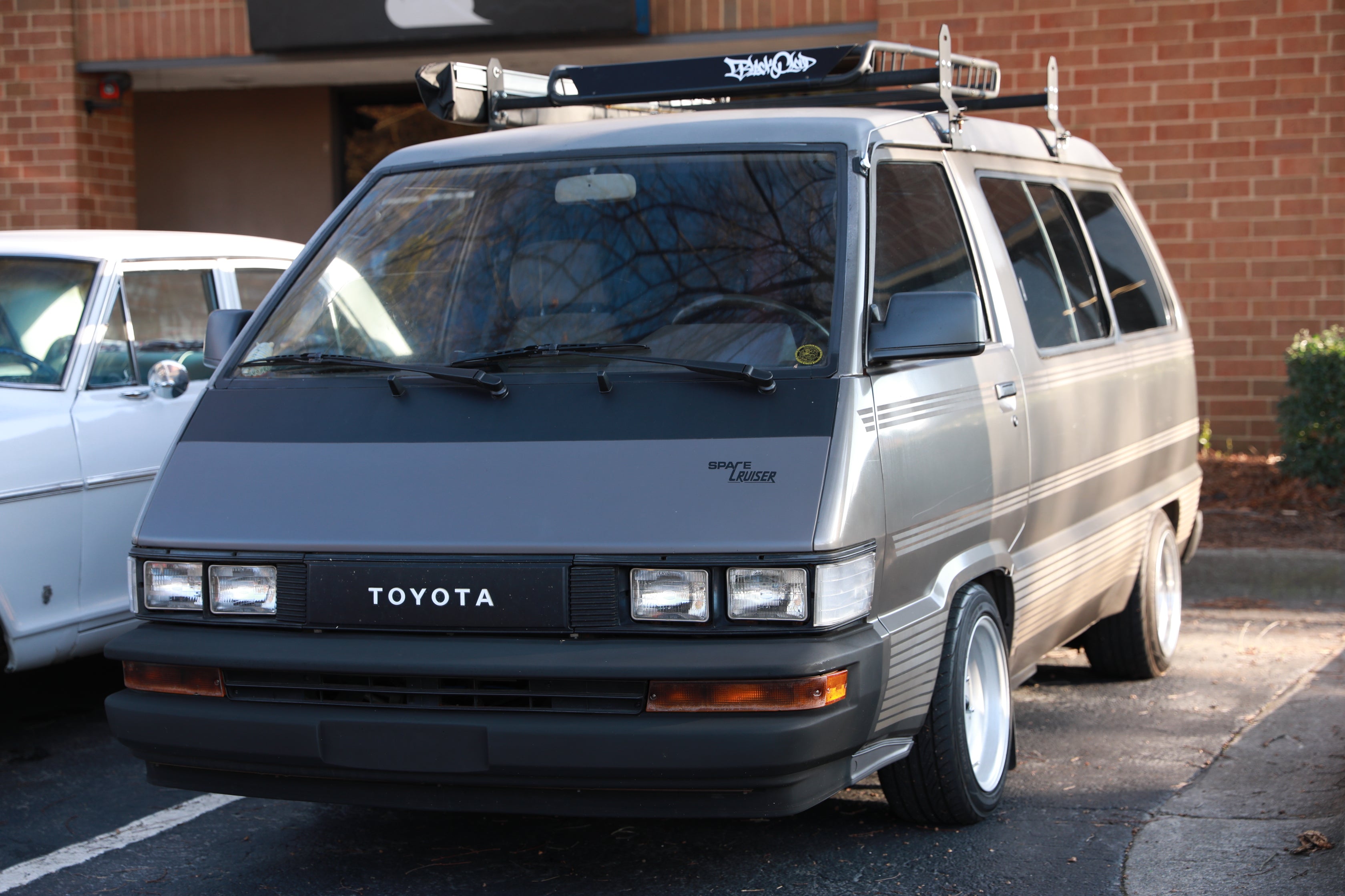 Black Cloud Tag White Vinyl Sticker on Toyota Van