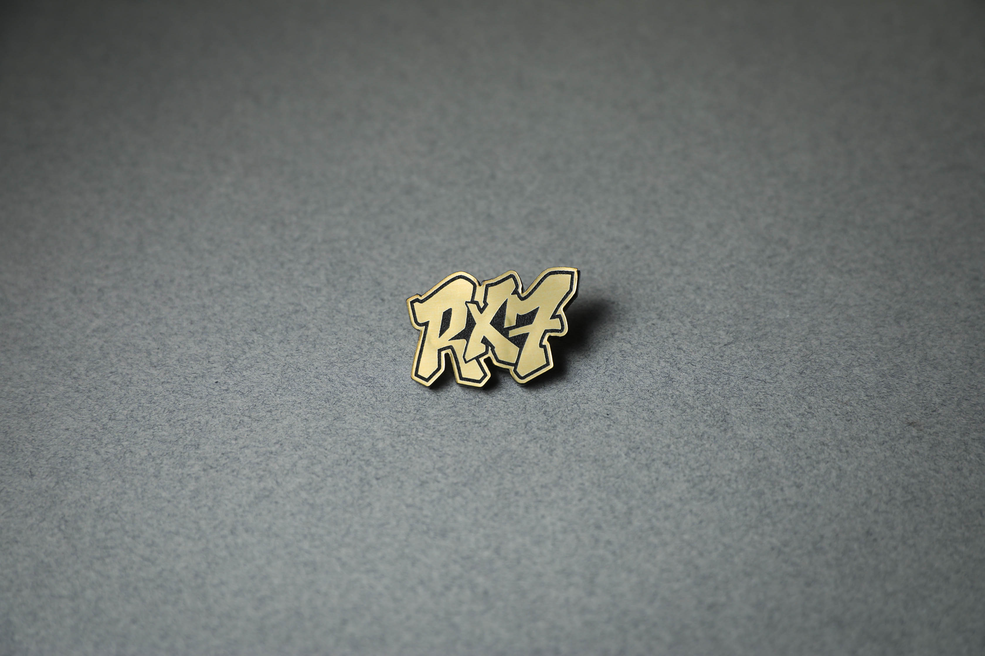 gold RX7 acrylic lapel pin