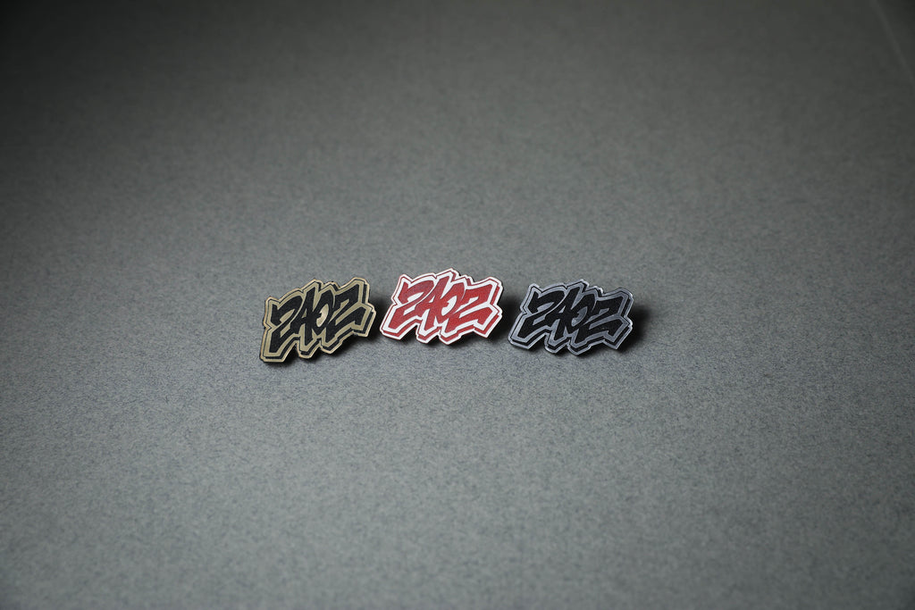 240Z acrylic lapel pin in gold, red or silver.