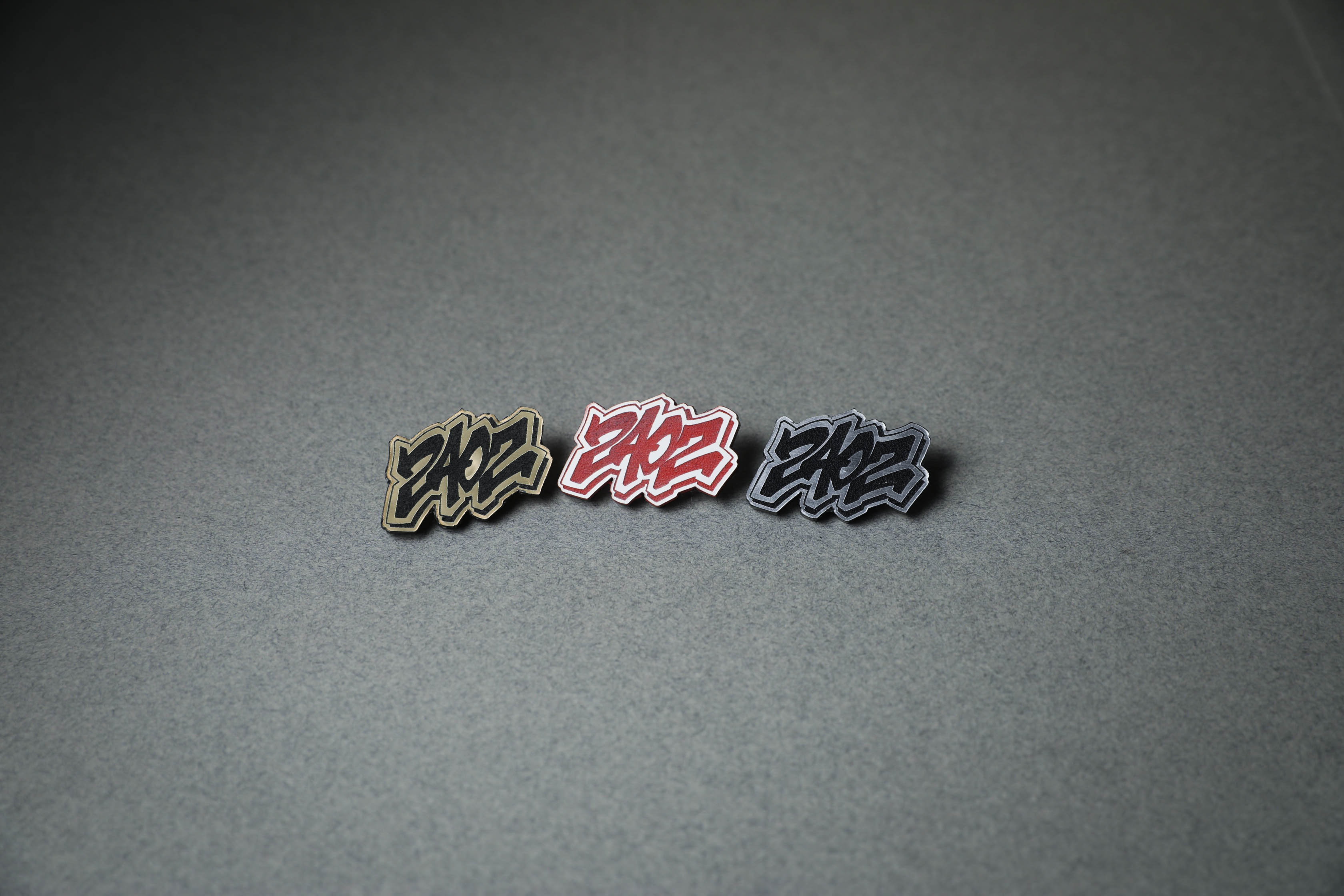 240Z acrylic lapel pin in gold, red or silver.