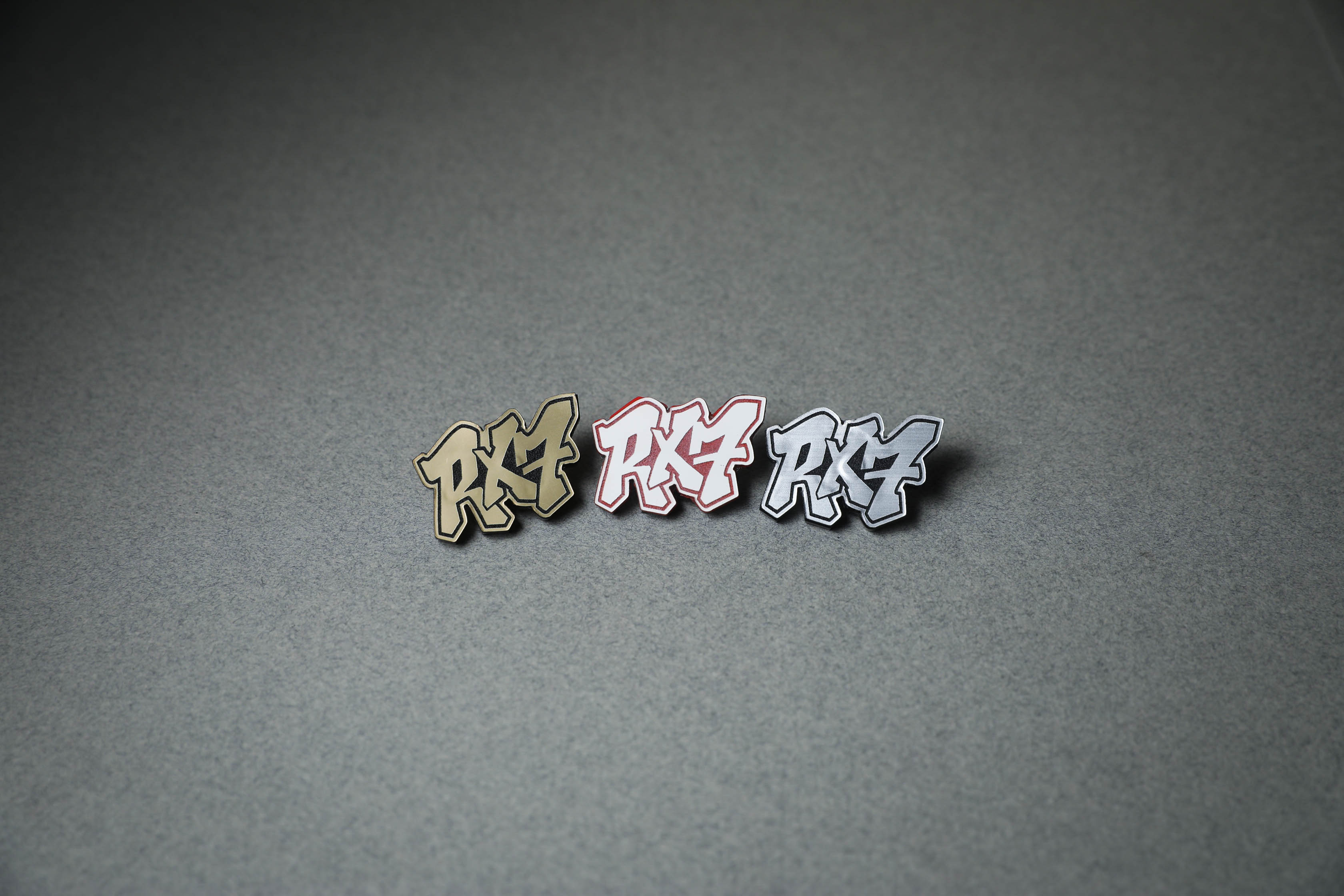 RX7 acrylic lapel pins in gold, red or silver