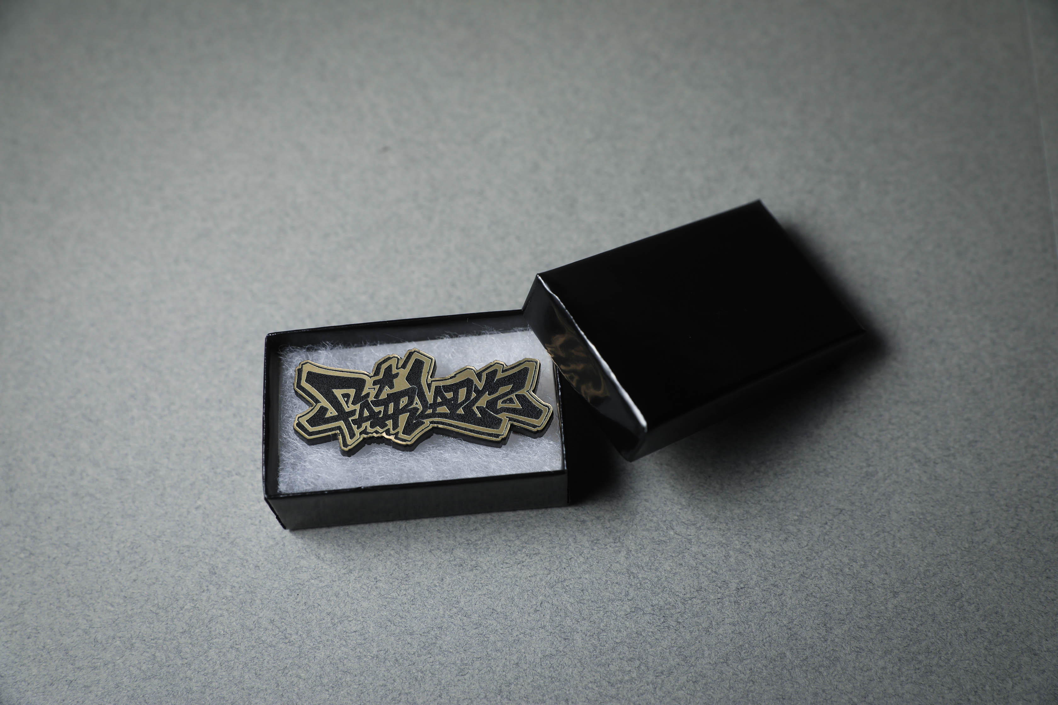 Fairlady Z gold acrylic lapel pin in jewelry box