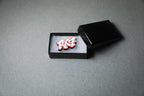 red RX7 acrylic lapel pin in jewelry box