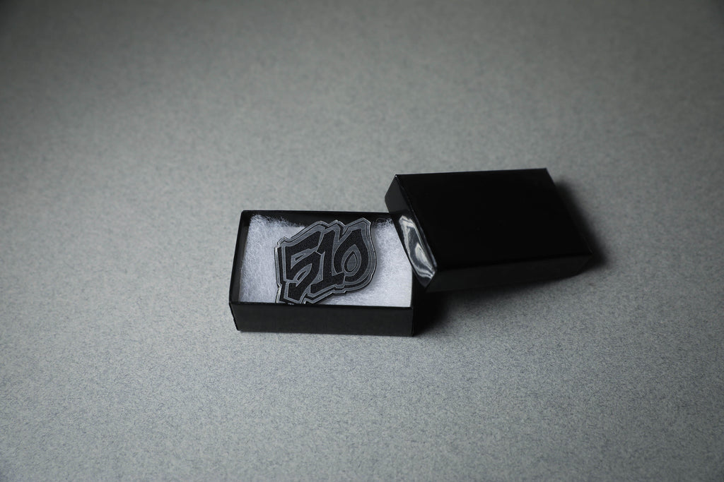 silver 510 acrylic lapel pin in jewelry box