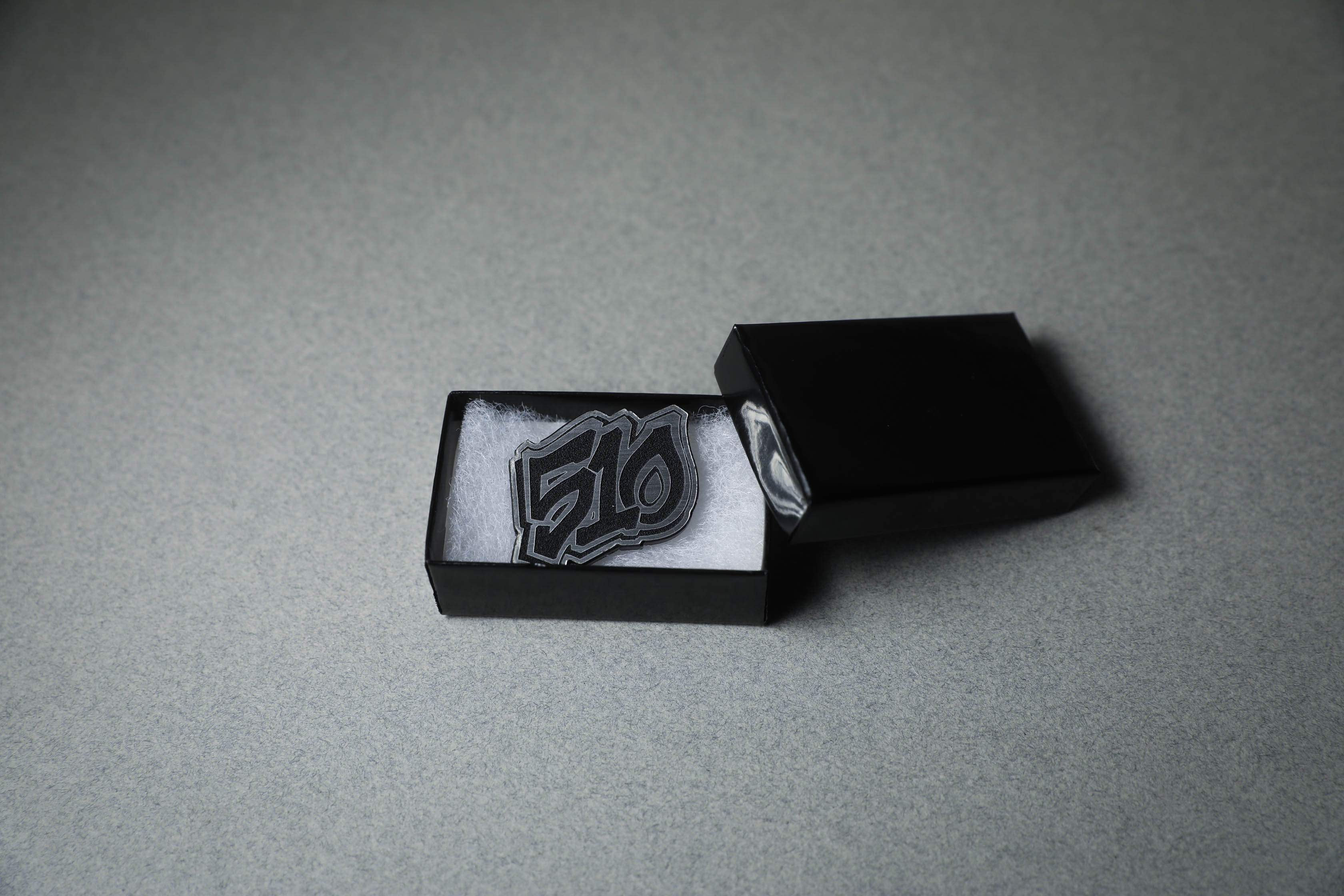 silver 510 acrylic lapel pin in jewelry box