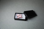 red driver acrylic lapel pin in jewelry box