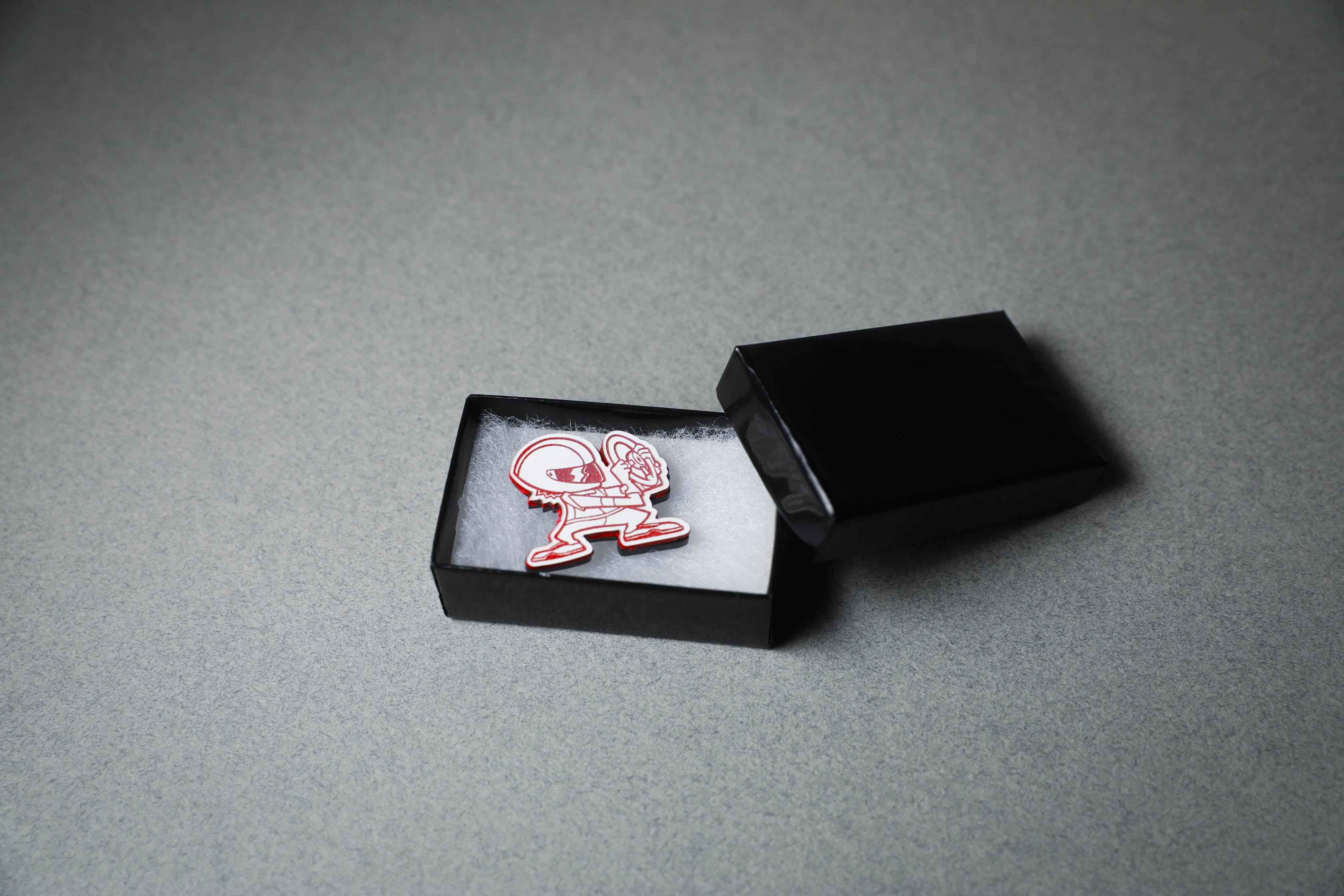 red driver acrylic lapel pin in jewelry box