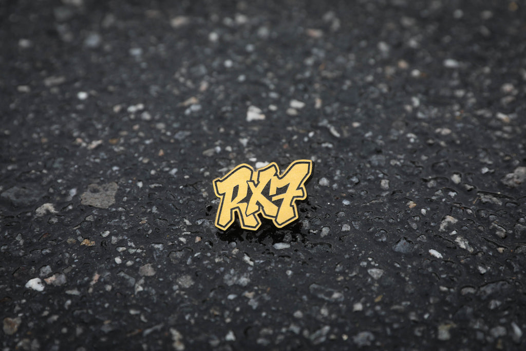 gold RX7 acrylic lapel pin