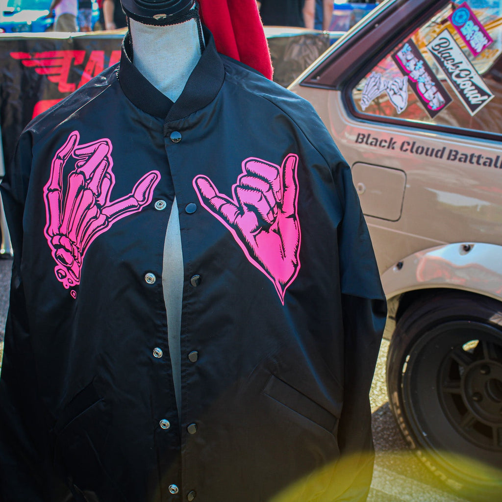 Black unisex nylon lined baseball jacket with promise (Yakusoku) design on front and black cloud Japanese kanji letters on the back in hot pink