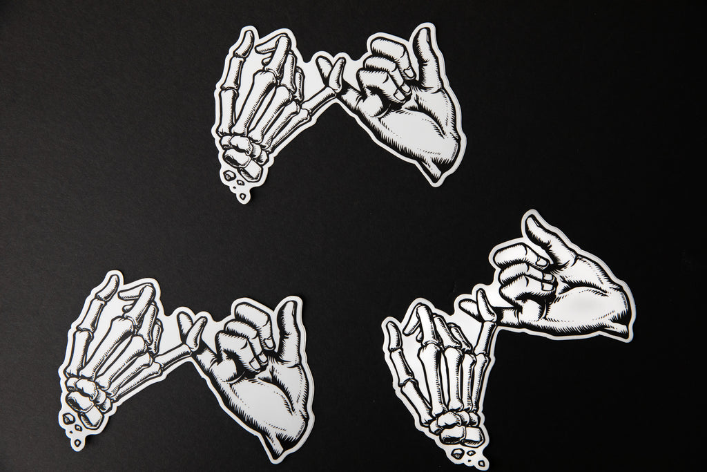 Multiple black and white Yakusoku (Promise) vinyl stickers.