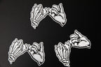 Multiple black and white Yakusoku (Promise) vinyl stickers.