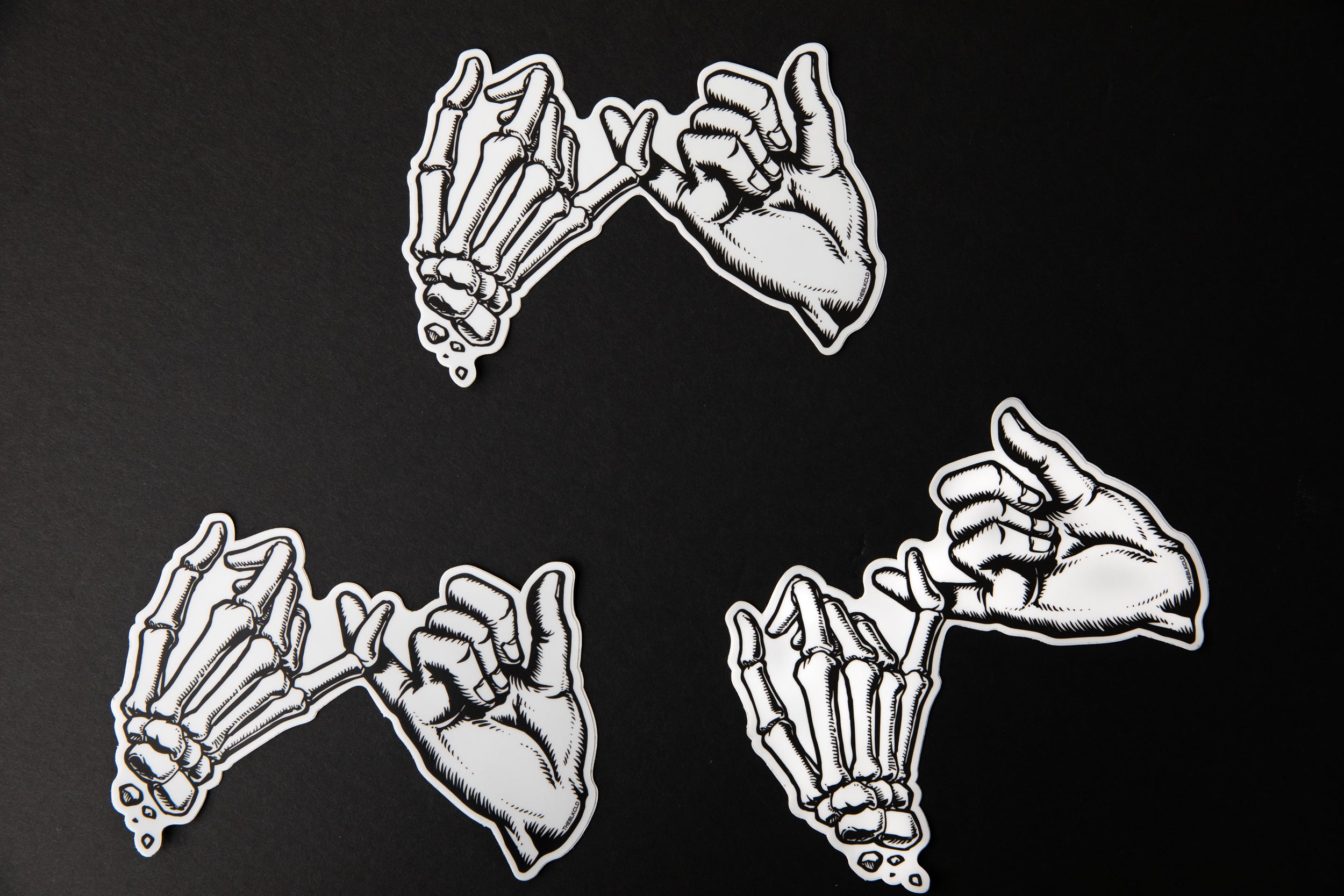 Multiple black and white Yakusoku (Promise) vinyl stickers.